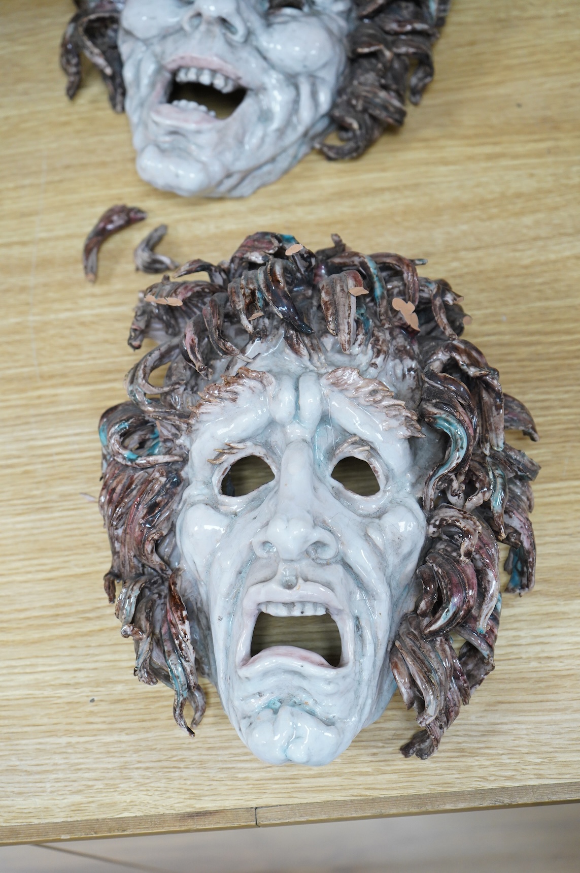 Eugenio Pattarino (1885–1971), two Italian maiolica comedy & tragedy wall masks, 30cm high
